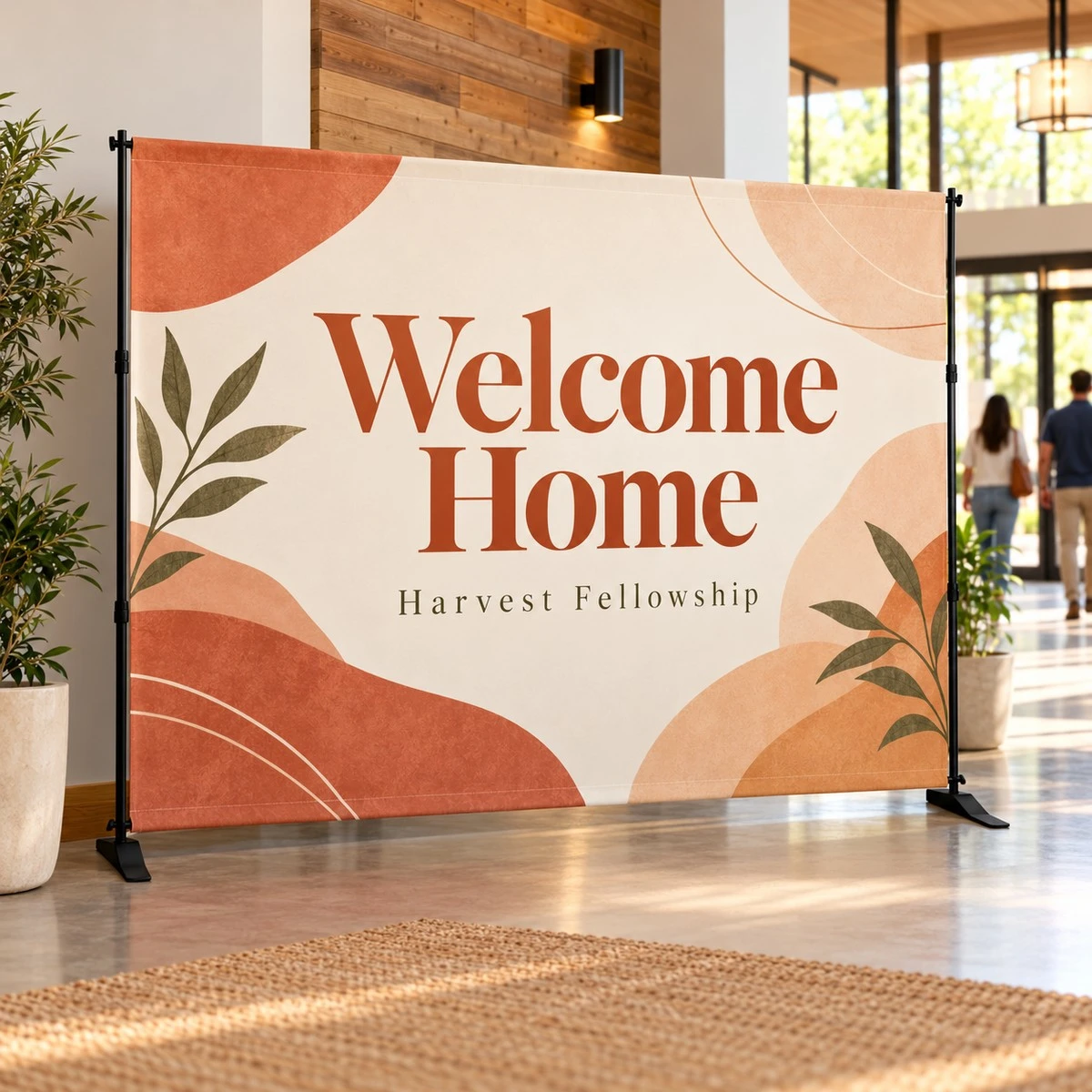 Welcome Home slider backdrop in cream and terracotta standing in a bright church lobby