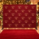 Burgundy step-and-repeat slider backdrop with gold Riverside Community Gala 2027 logos and a red carpet